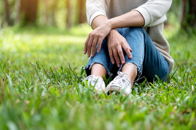 Closeup image of a woman sitting and relaxing in the park