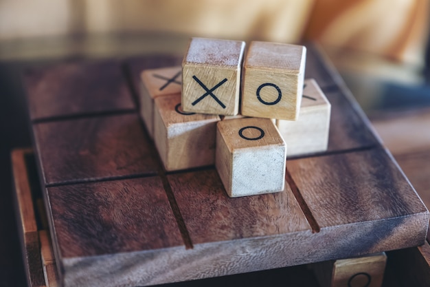 Closeup image of wooden Tic Tac Toe game or OX game in a box