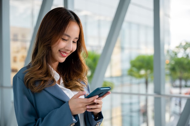 Closeup image of young woman using modern smartphone device for messaging and browsing social media apps lifestyle woman working