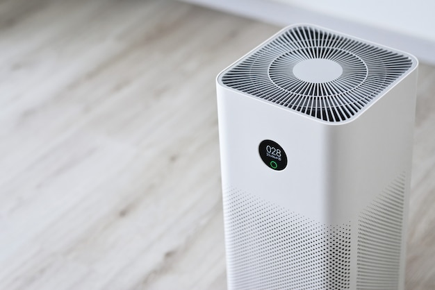Closeup of an indoor Air purifier in the room is very safe and clean to breathe while dust air pollution situation outside is really bad protect PM 25 dust and air pollution concept Air purifier
