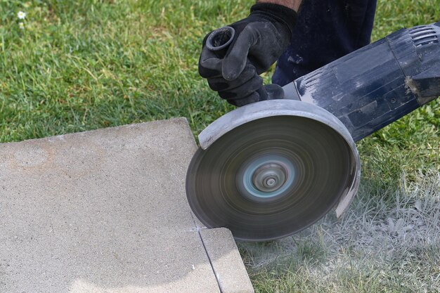 Closeup of an industrial construction worker using a professional angle grinder