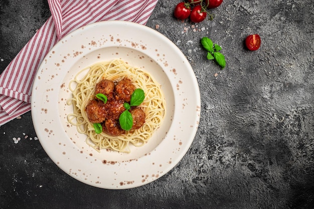 Closeup of italian pasta with tomato sauce and meatballs\
restaurant menu dieting cookbook recipe top view