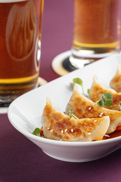 Closeup on japanese gedza dumplings with beer