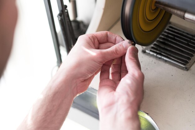 CloseUp Of Jewelry Hands Maker Using Polishing Machine