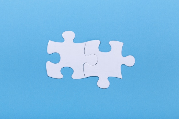 Closeup of jigsaw puzzle on blue Missing jigsaw puzzle piece