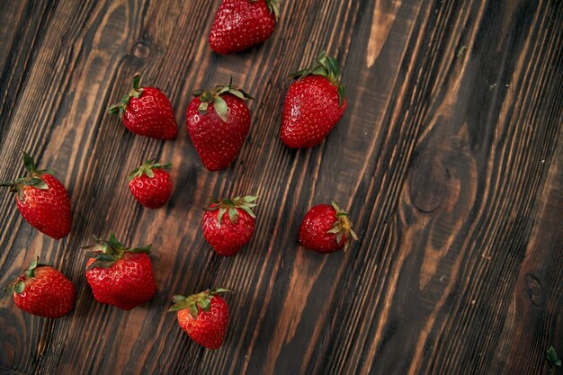 Closeup juicy strawberries on a wooden background