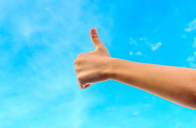 Closeup of kids hand showing thumbs up sign