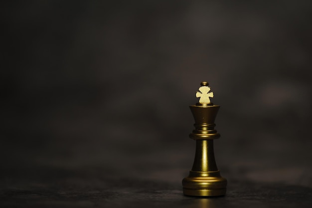 Closeup king chess standing on black background