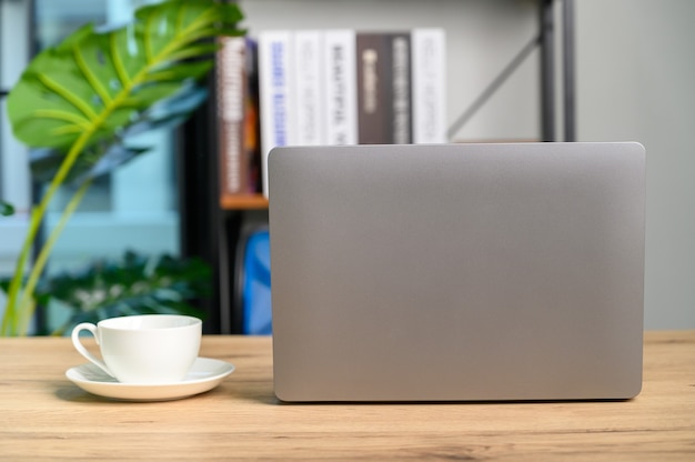 Closeup of laptop computer with office supplies in modern office on desk