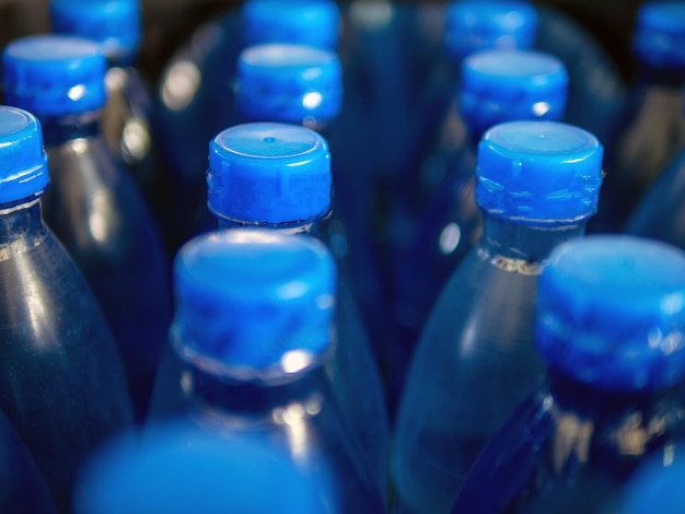 Closeup of large number of packed blue bottled drinking water with blue capsdrinking water bottle