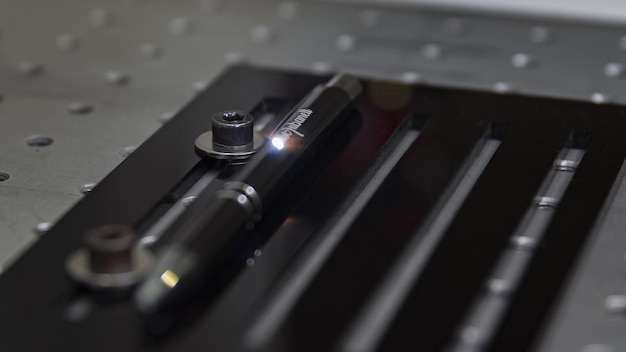 Closeup laser engraving action on a black pen