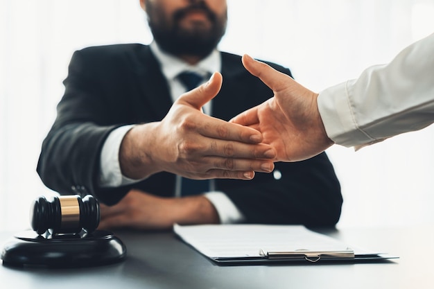 Closeup lawyer colleagues or legal team handshake equilibrium