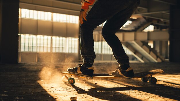 Photo closeup of legs and sneakers on skateboard