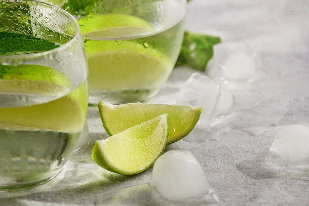 Closeup lime and mint water alcohol or non alcohol drink. detox water. Morning light, selective focus. Mojito