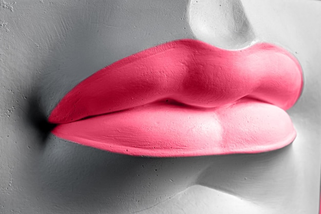 Closeup of a Lip in Viva magenta Plaster elements in a modern style Creative figurine made of plaster