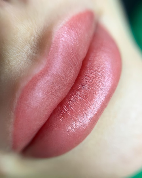 Closeup of lips with permanent lip makeup procedure macro shot of lips with eyebrow tattoo