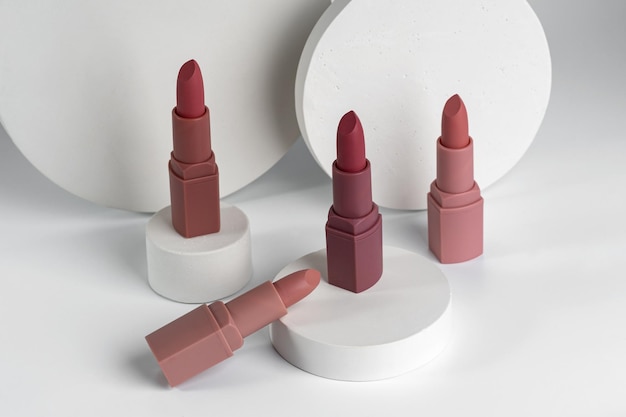 Closeup of Lipsticks With Different Colorful Tones samples showing on white concrete podiums