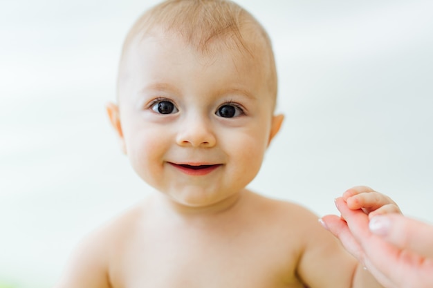 Closeup of a little baby in clinic. Cute patient. Happy child on white background.