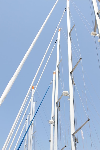 Closeup of a lot of masts against the sky with no sails