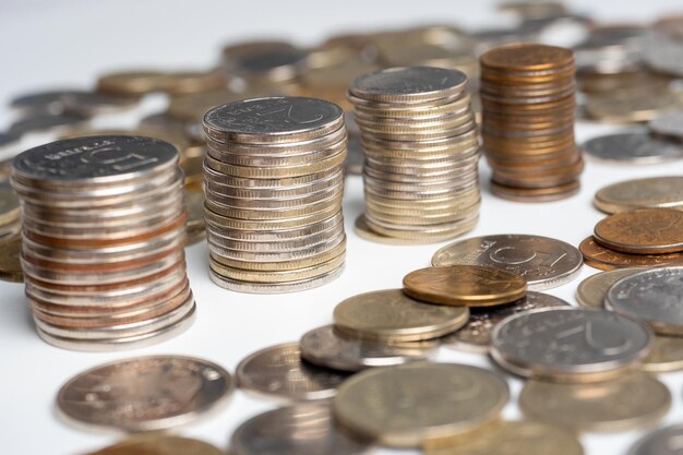 Photo closeup of a lot of russian ruble coins on a white background columns of coins