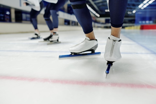 Closeup of lower part of legs of young sportsman in skates