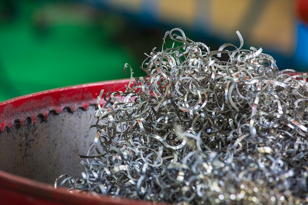 Closeup machined steel  twisted spiral steel in tank shavings industry