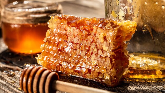 Closeup macro of bee honeycomb in a hexagon with sealed golden sweet honey in nature