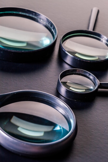 Closeup of magnifying glass on dark surface