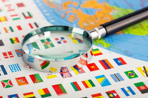 Closeup of magnifying glass on the flags of the countries