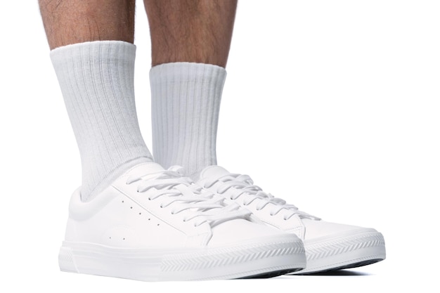 Closeup of male feet and shoes Man wearing white trainers isolated on white background