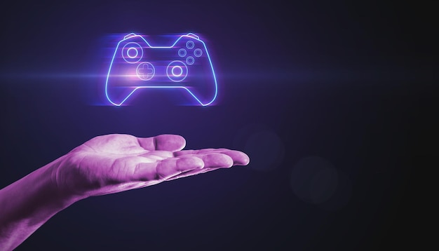 Closeup of male hand pointing at creative joystick or gamepad hologram on blurry purple bokeh background Esport gaming and fun concept