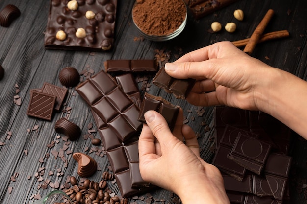 Closeup male hands breaking a bar of chocolate