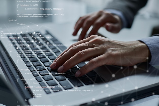 Closeup of male hands using laptop at office