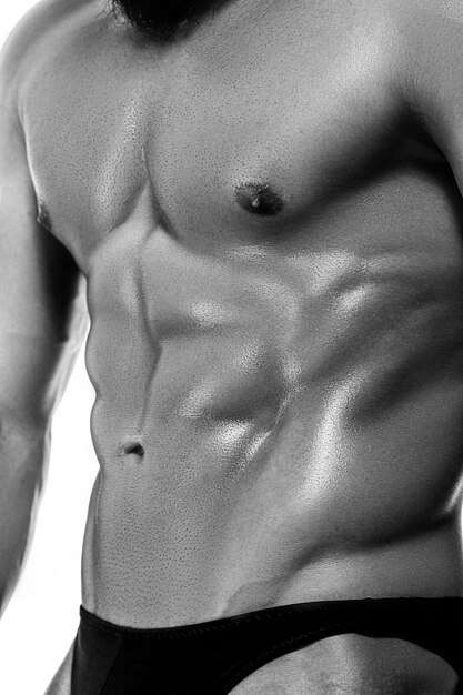 Closeup of man bodybuilder showing muscular body.