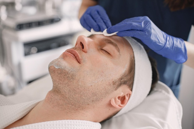 Closeup on a man in cosmetologist cabinet has a skincare procedure