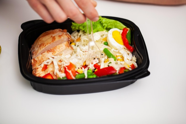 Closeup of a man holding a box full of protein rich foods for sports nutrition.