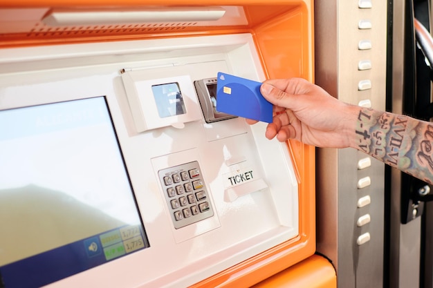 Closeup of a man paying with a credit card at a gas station