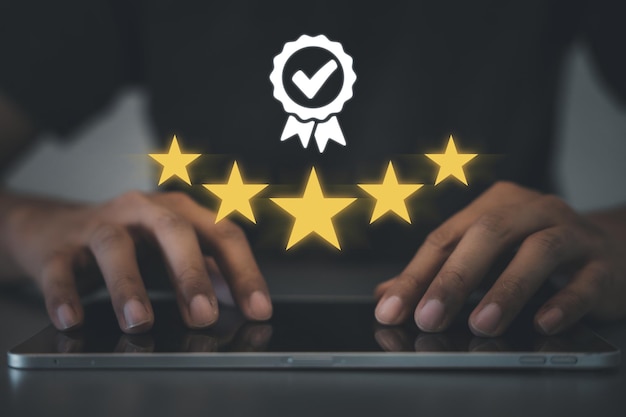 Closeup of man's hand using smartphone to rate service with 5star feedback icon