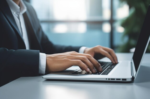 closeup of man typing on laptop with plain white screen