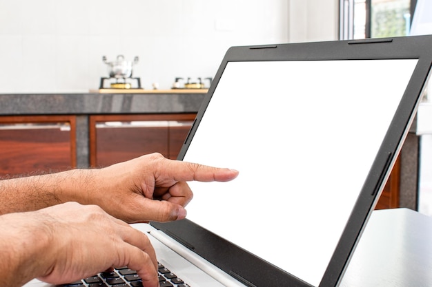 Closeup A mans hand is a touch on a laptop blank screen to search out how to cook