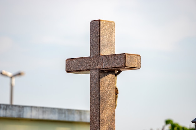 Closeup of marble cross of grave in cemetery