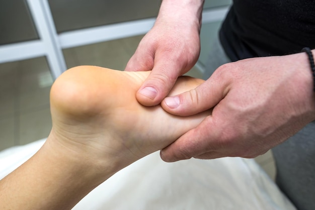 Closeup massage of a female foot in a spa salon