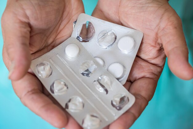 A closeup of medical pills in the hands of an elderly man a notion of health and medicine