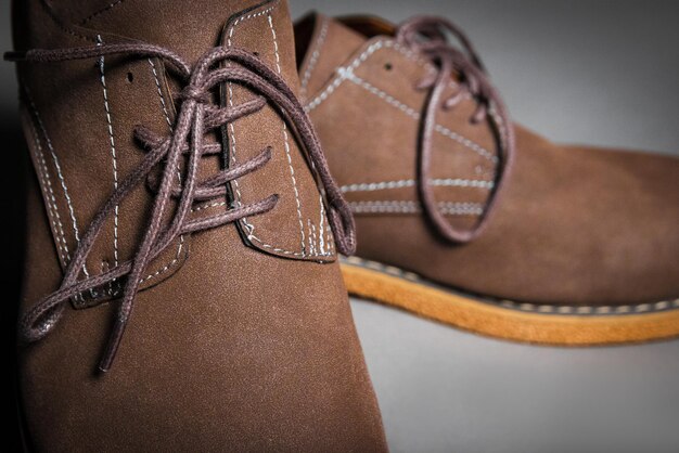 Closeup of men's shoes in brown with laces tied in a bow