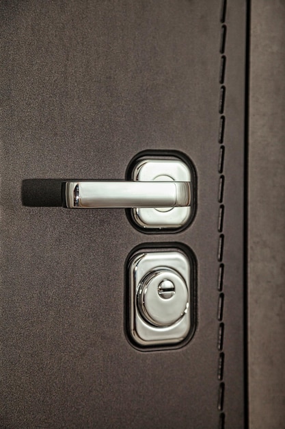 Closeup metal handle armor door and door lock on white\
background