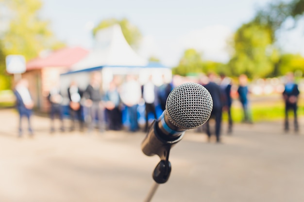 Closeup microphone in blurred background with effect film bright light filter, single microphone in the park and blurred background.