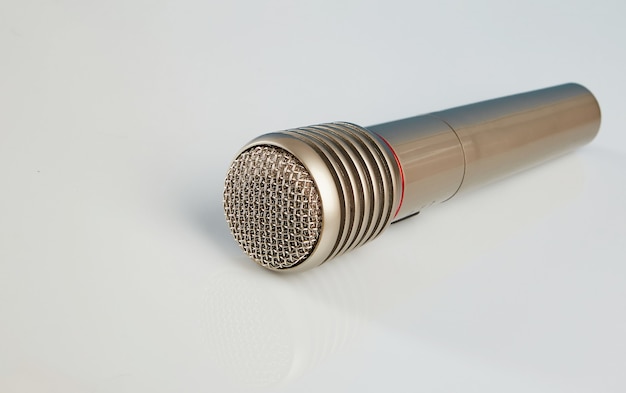 Closeup microphone on a white mirrored table