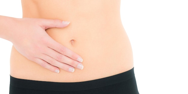 Closeup mid section of a fit woman with stomach pain