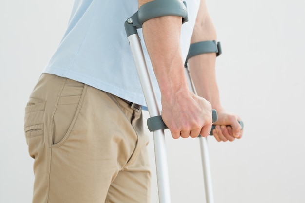 Closeup mid section of a man with crutches