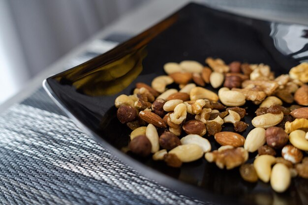 Photo closeup of mixed nuts and raisins in bowl